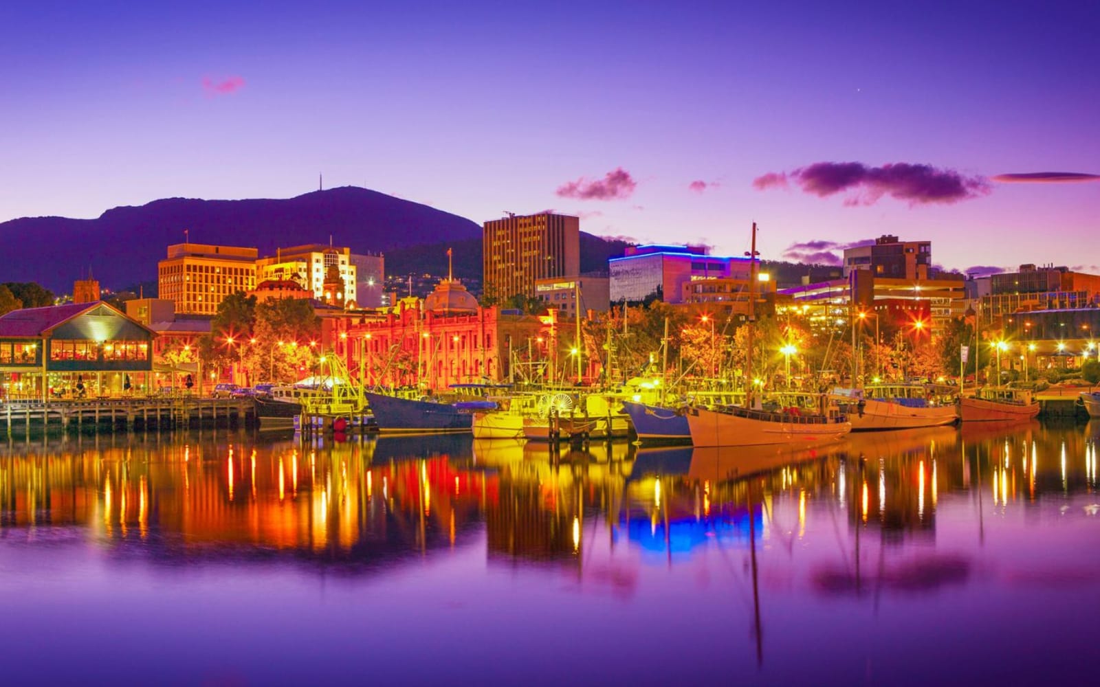 The city of Hobart lit up and reflecting onto the Harbour