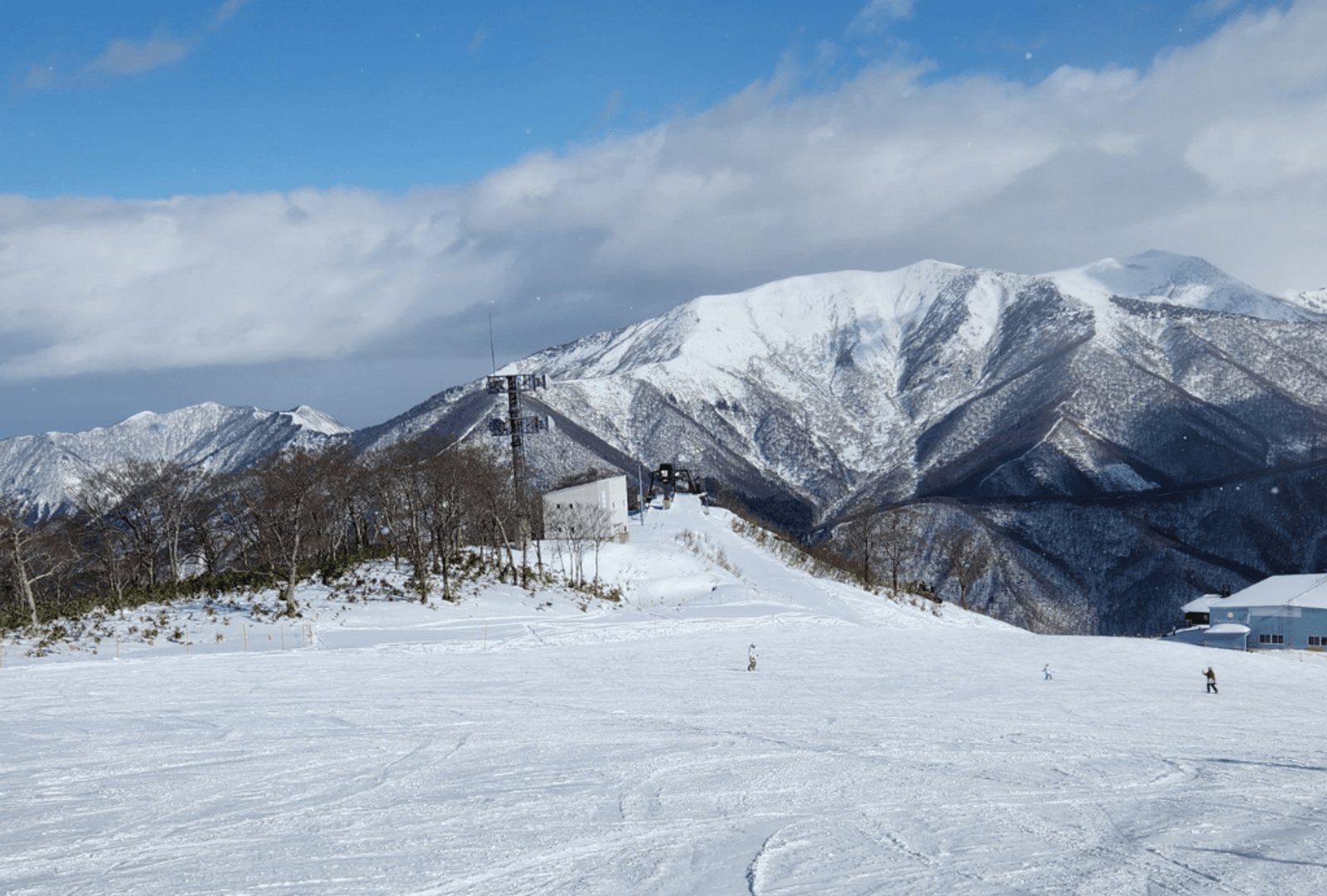 A snow-covered ski slope on a sunny day