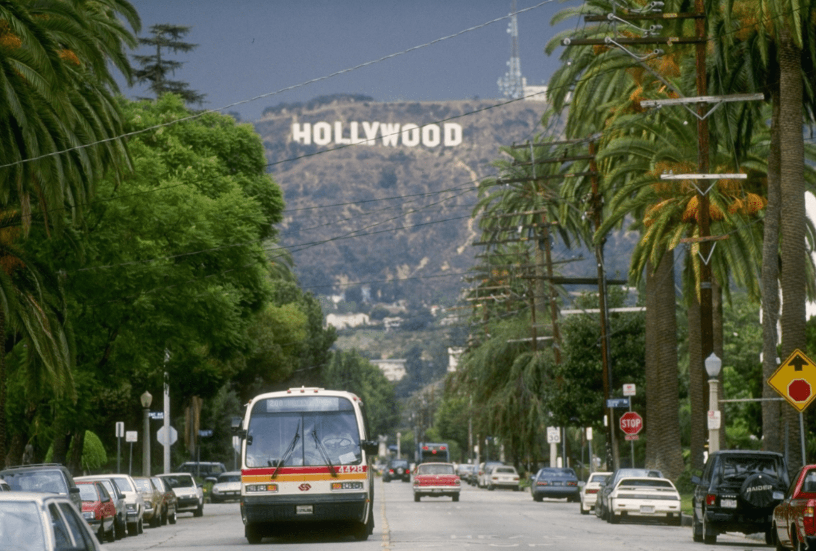 Street view of Hollywood with the iconic hill sign in the background