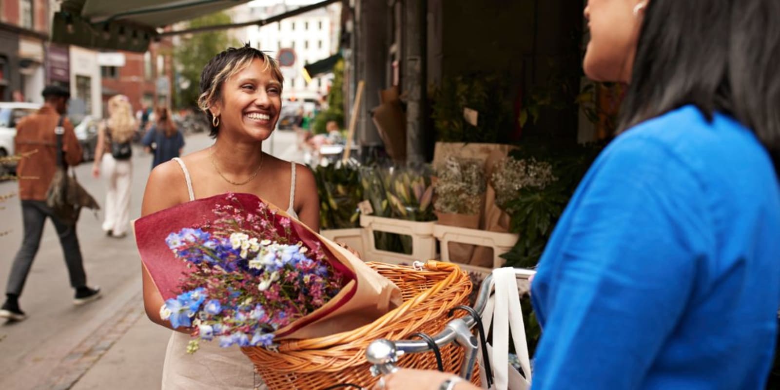 A person buying flowers from a street market