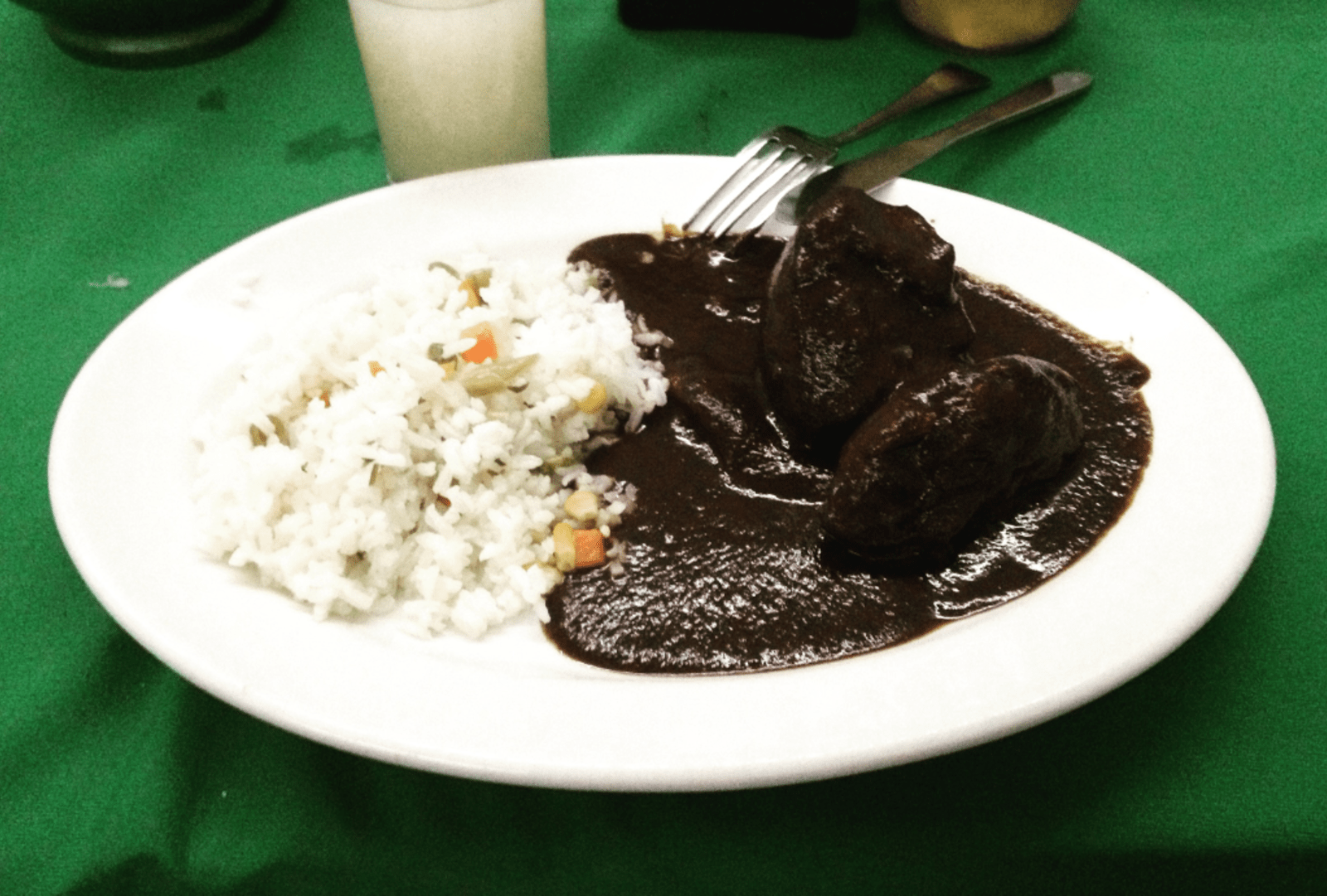 A Mexican meal served with mole sauce.