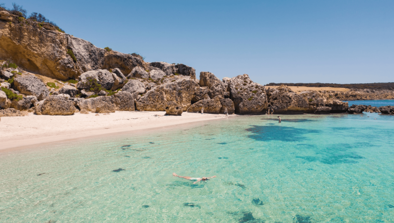 Person floats in crystal blue water Stokes Bay Kangaroo Island