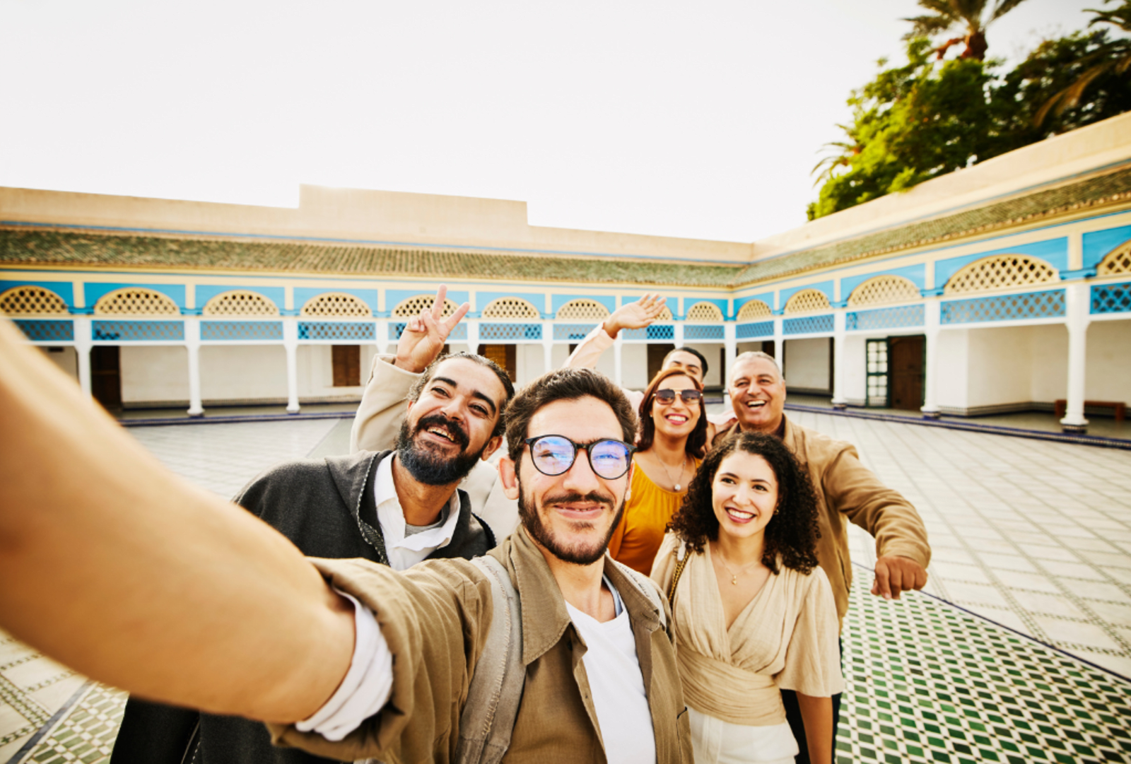 A family smiles while taking a selfie 