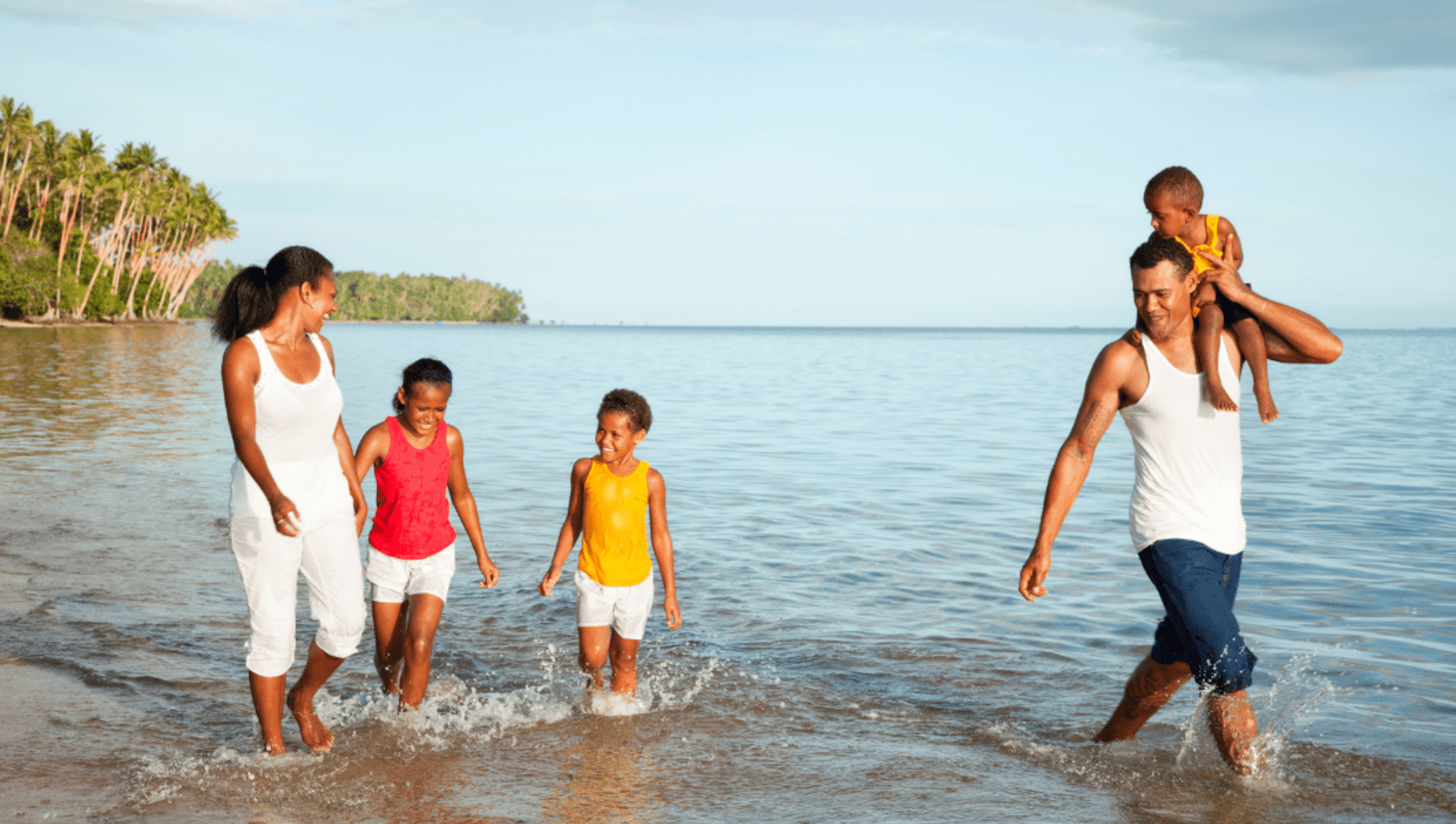 family plays in water in Fiji