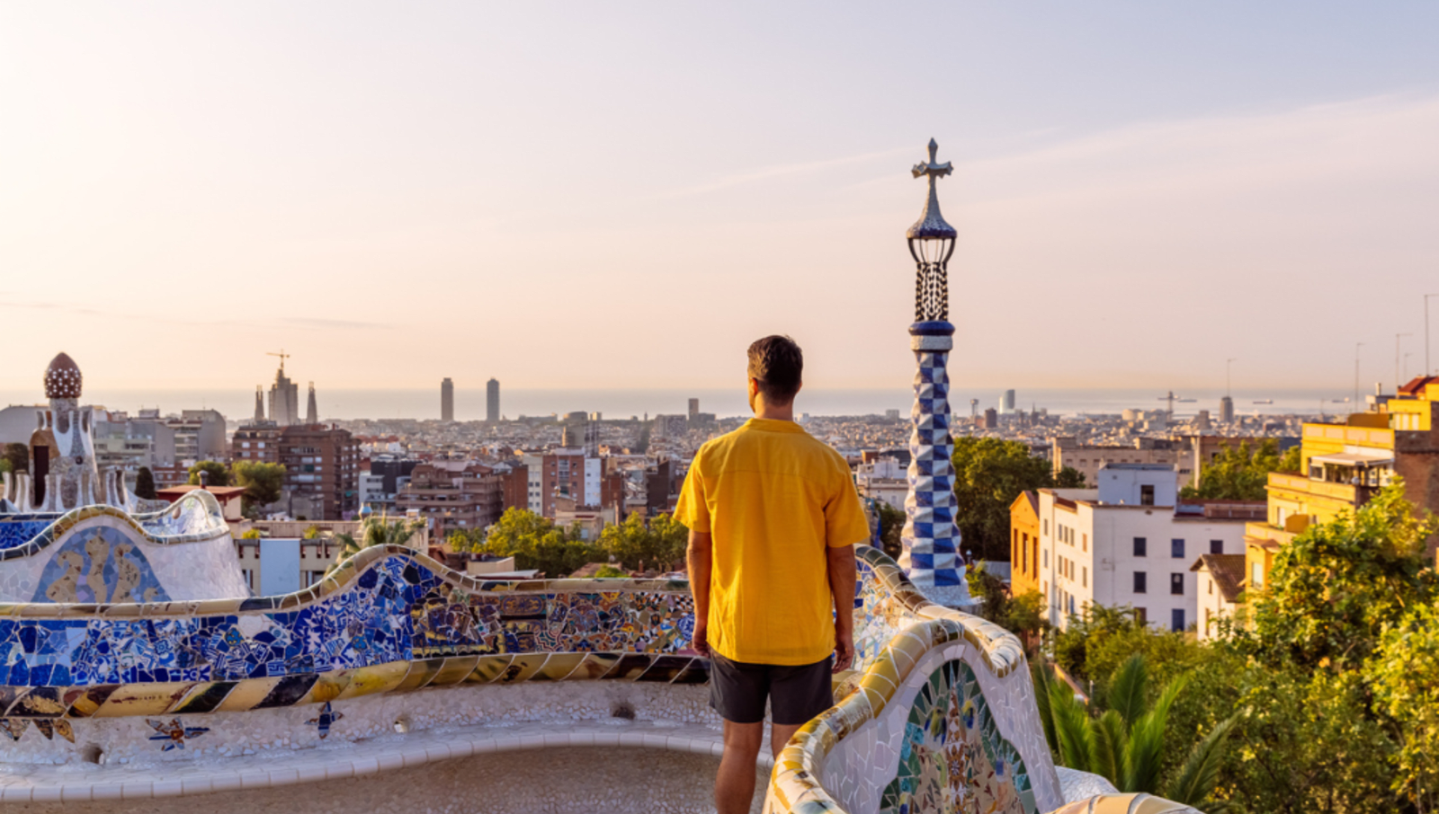 man standing at lookout in barcelona overlooking city