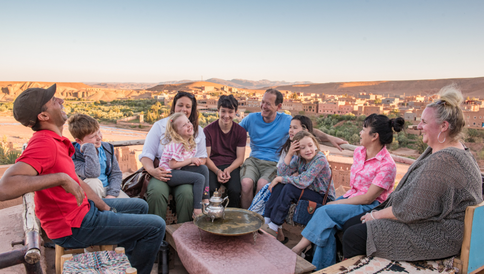 Family sitting on chairs around a table 