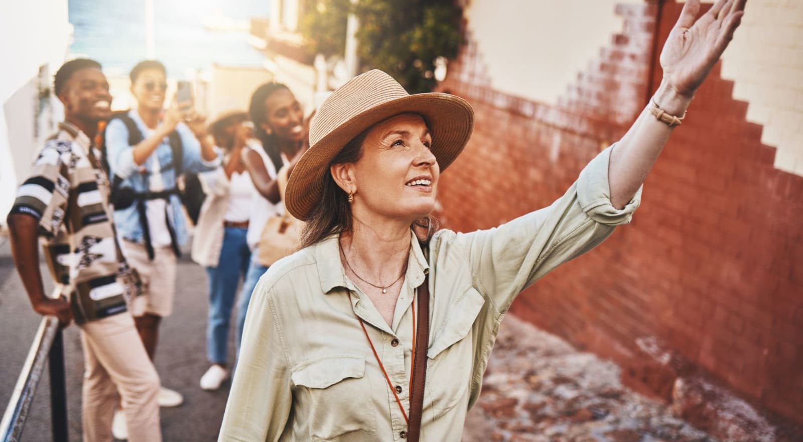 lady showing group of young travellers something