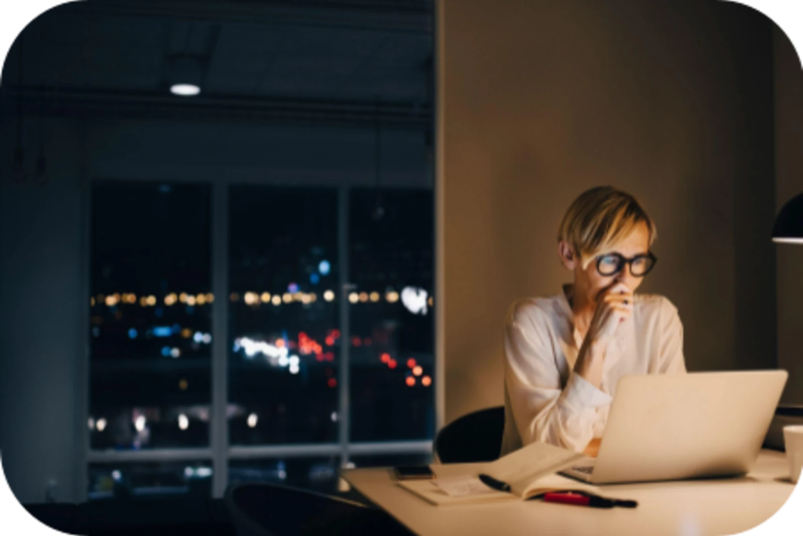 A lady is watching the laptop at evening 