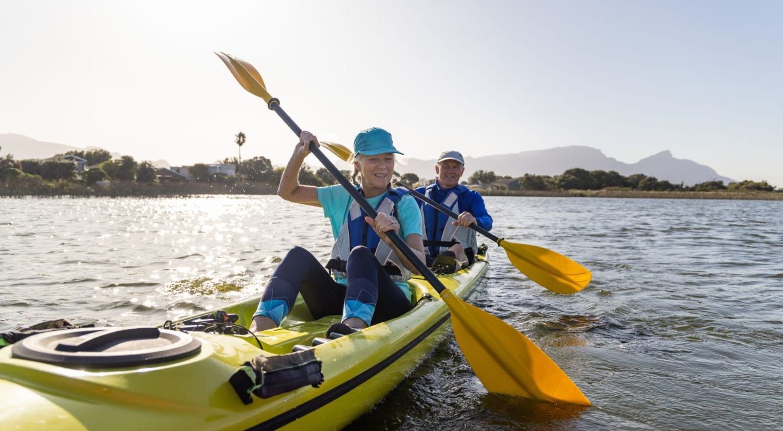 old couple kayaking on river