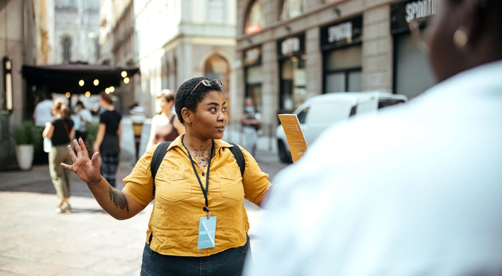 lady leading group of tourists in city