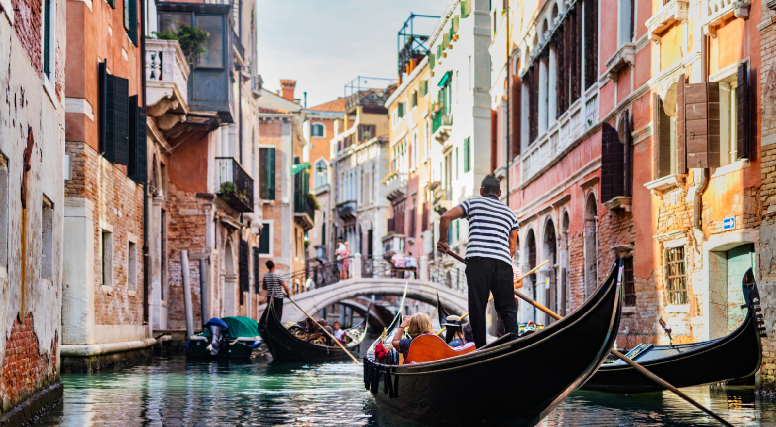 gondola with people on it going through venice