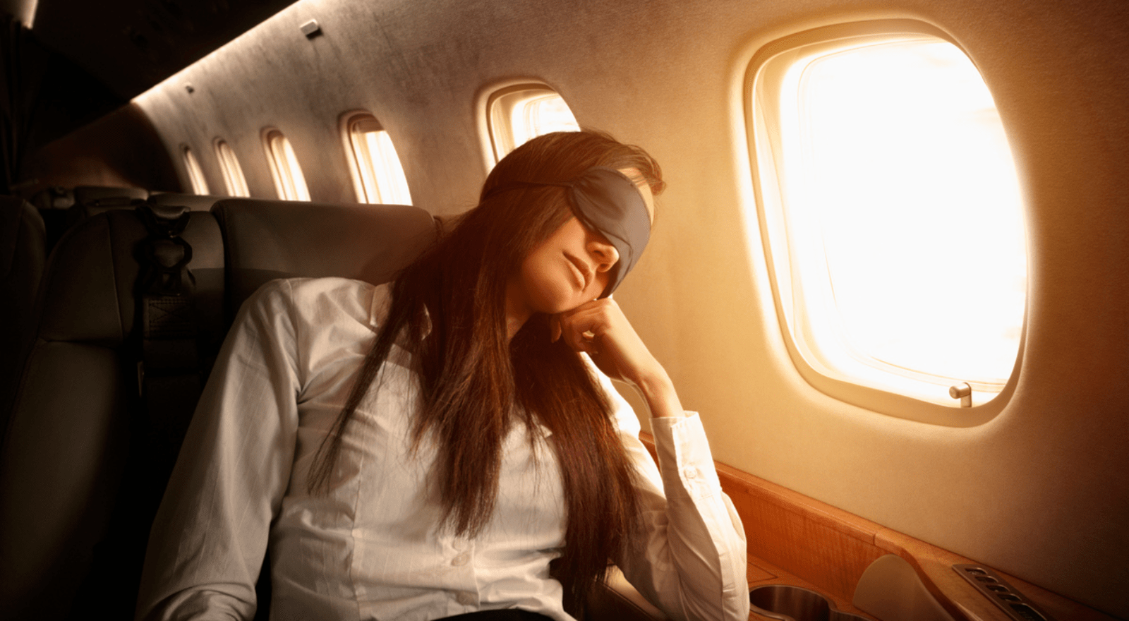 lady with eye mask sleeping on plane