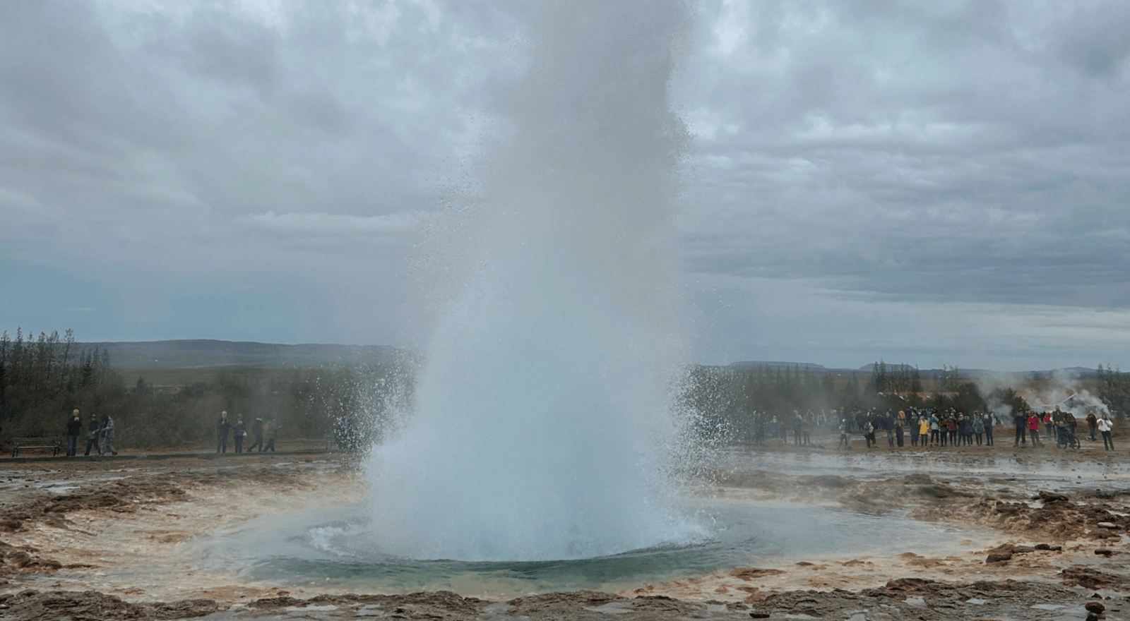 Strokkur geyser erupting in geothermal area of Iceland