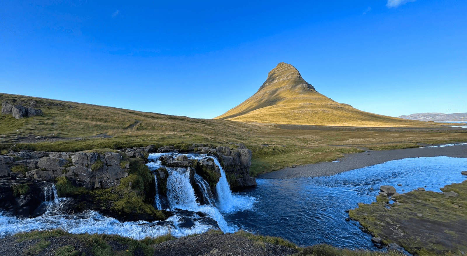 Kirkjufell mountain against a blue sky on the Snæfellsnes Peninsula in Iceland