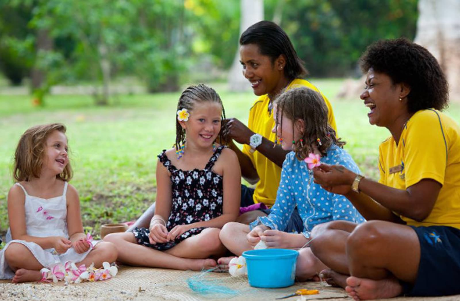  Tourists children having fun with fiji locals at the garden