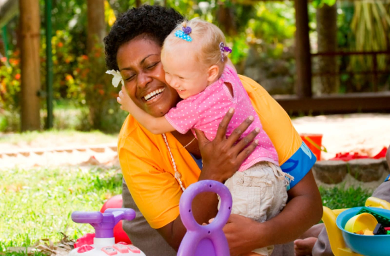  Nanny holding a baby while playing