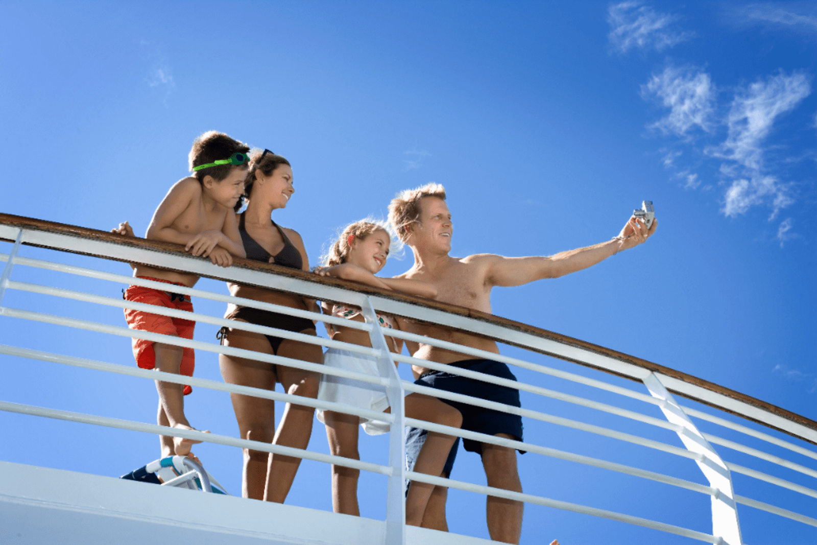 A family taking a selfie on the deck of a cruise ship