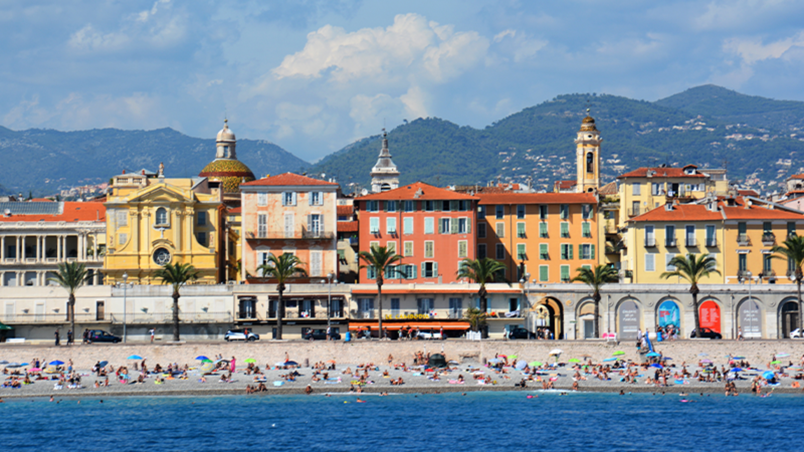 People relaxing and playing on the beach of Nice