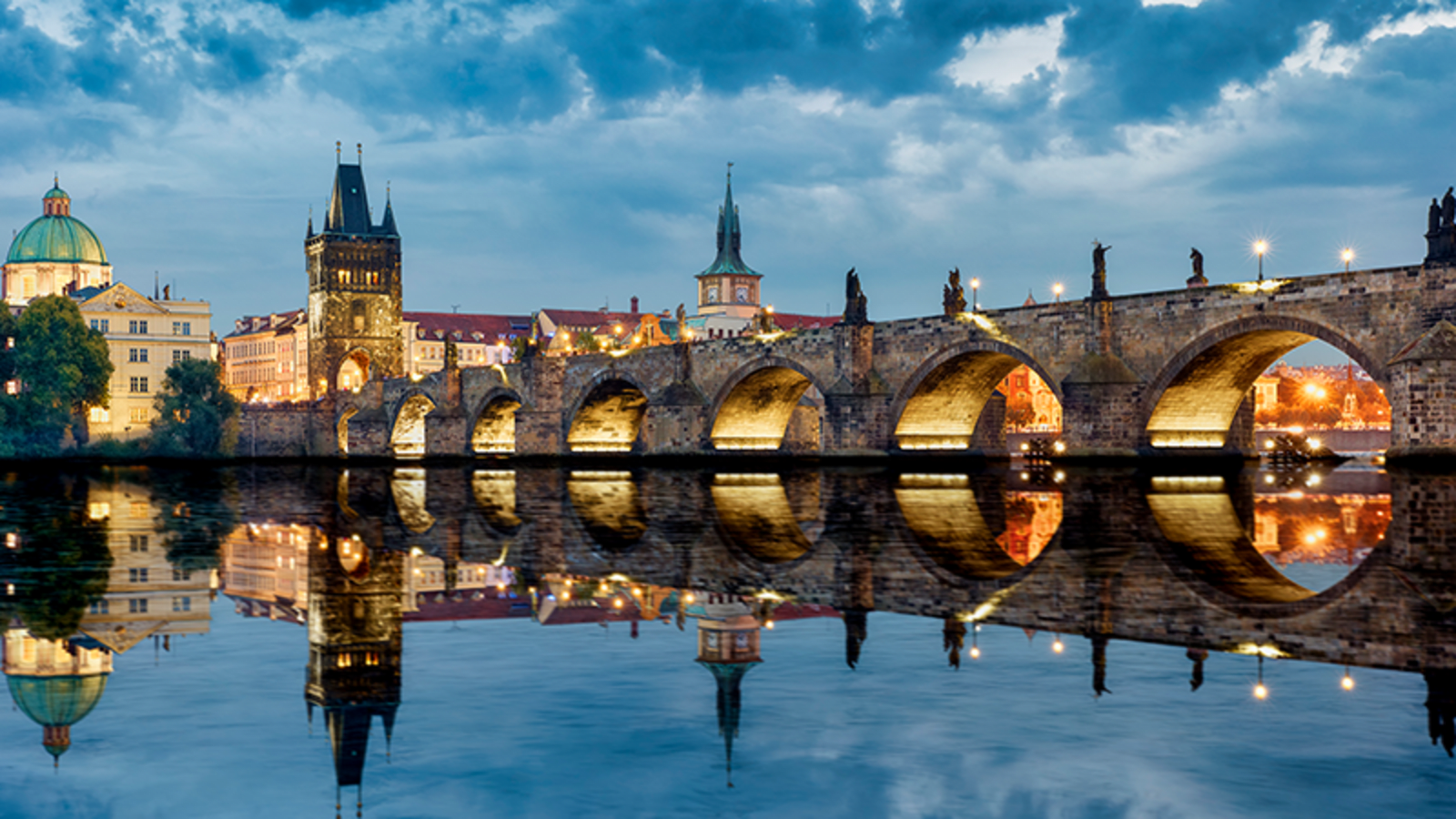 Beautifully lit bridge over a river in Prague