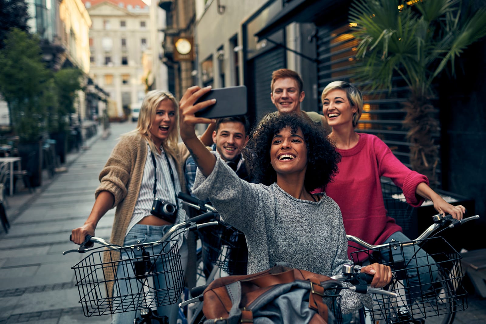Group of people riding bikes and taking a selfie