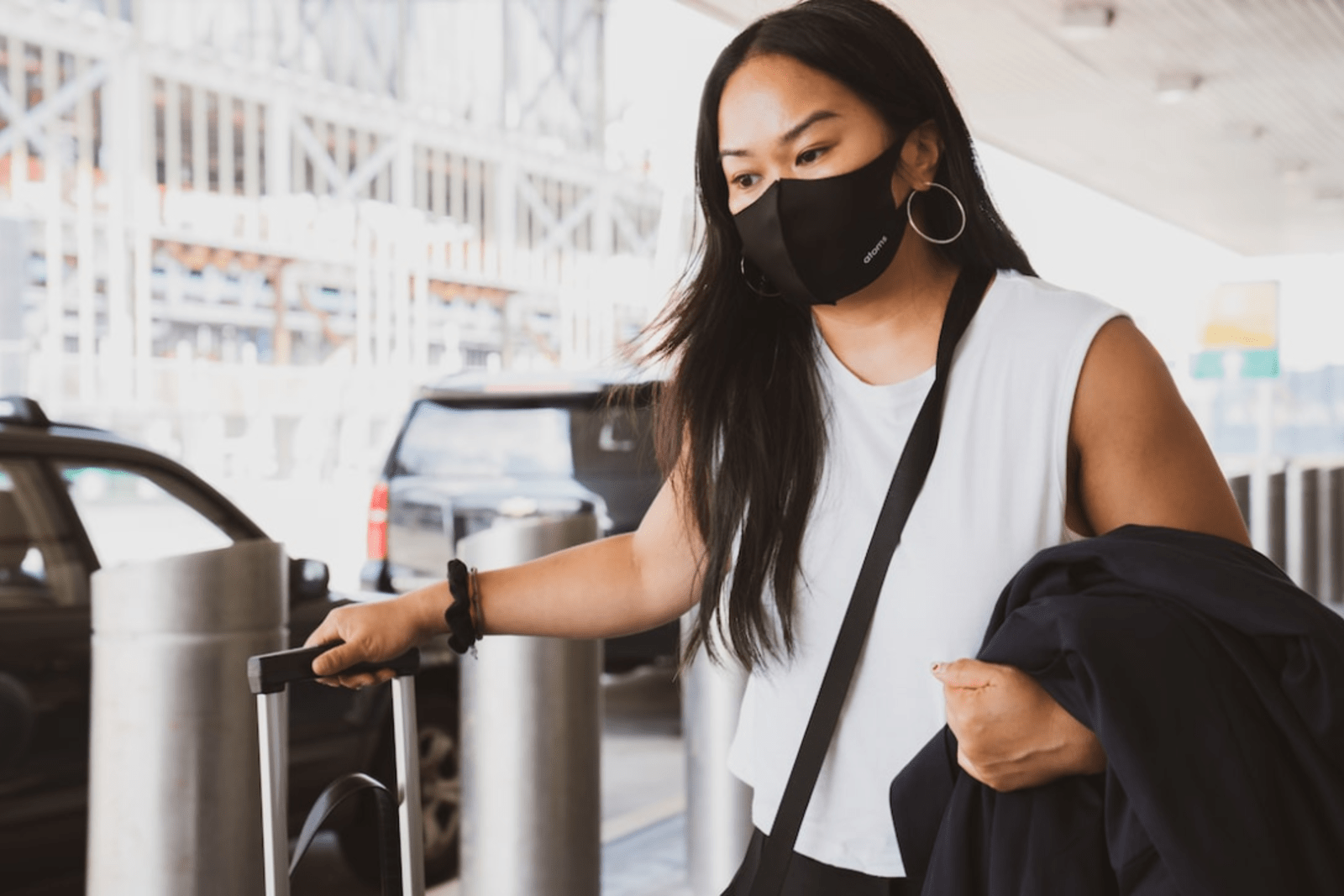 A woman wearing a mask outside an airport