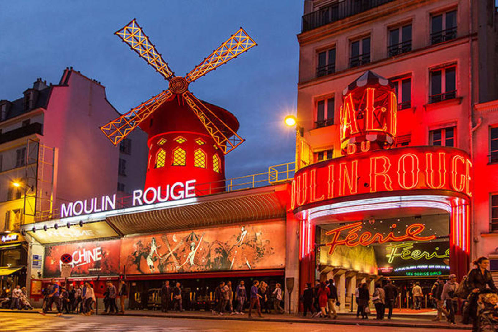 Moulin Rouge Cabaret building in Paris - lit with neon red lights, and featuring a windmill replica