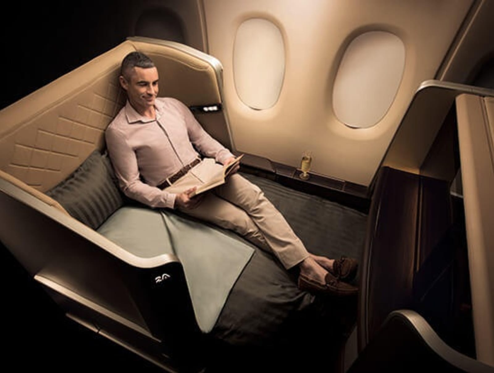 RS-New-First-class-man-reading-book-in-suite.jpg