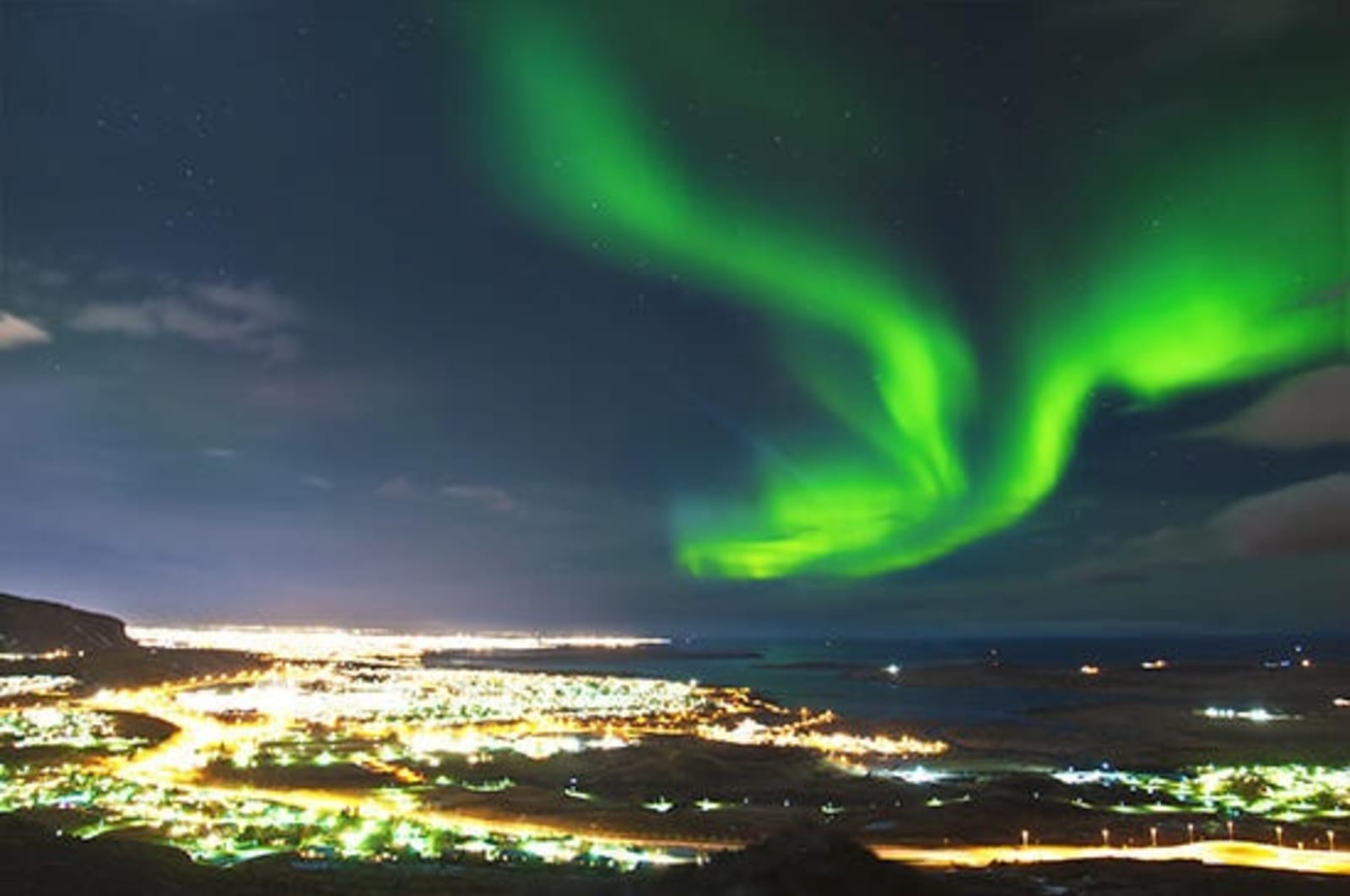 Image of Northern Lights over city at night