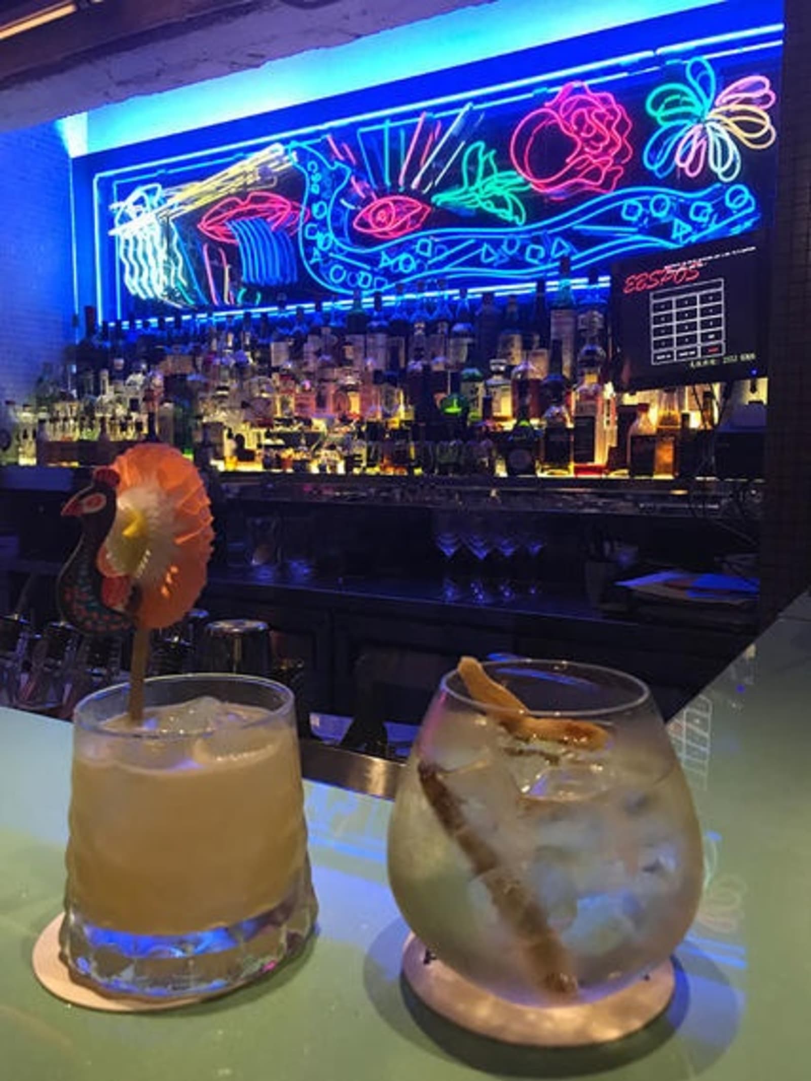 Two cocktails at a bar.
