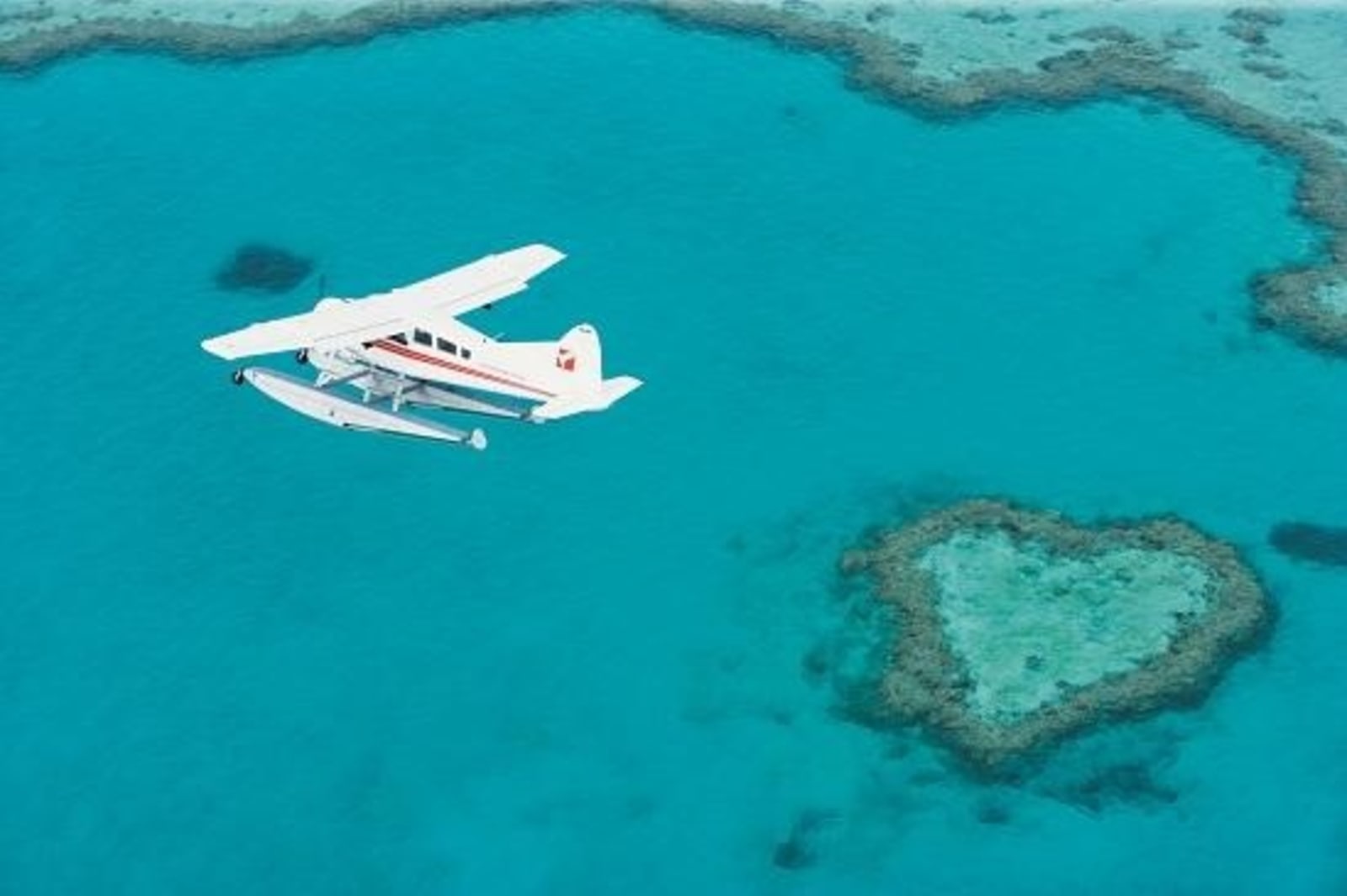 Plane flies over the Heart Reef.