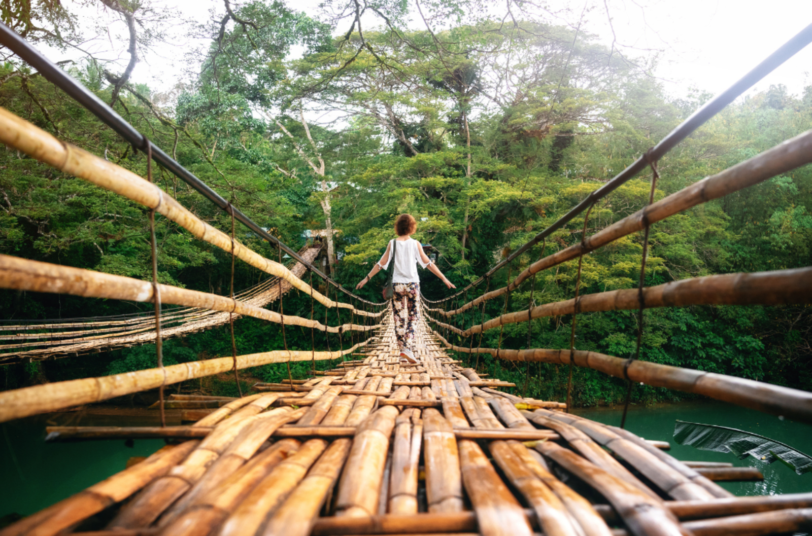 Woman walking along a bridge in the Philippines