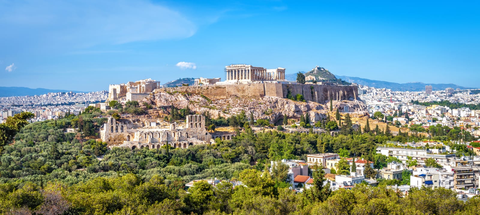 Panorama of Athens with Acropolis hill, Greece. Famous old Acropolis is a top landmark of Athens. Ancient Greek ruins in the Athens center in summer. Scenic view of remains of antique Athens city.