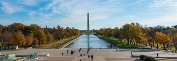 Wide shot of Washington Monument with people looking from a far