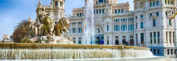 Close up of the lions on the Cibeles Fountain with palace in background