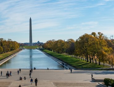 Wide shot of Washington Monument with people looking from a far