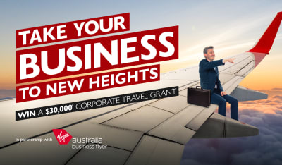 Take your business to new heights | win a $30,000* corporate travel grant. Businessman sitting on the wing of a plane
