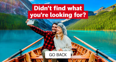 Didn't find what you're looking for? Go Back | Couple in a rowboat taking a selfie with pine tree forests and snowy mountains in the background