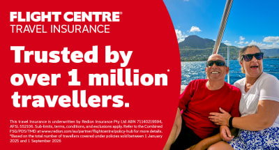 Couple smiling on a cruise yacht, celebrating Flight Centre Travel Insurance trusted by over 1 million travellers