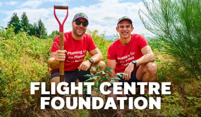 Flight Centre Foundations | two flight centre staff kneeling planting trees