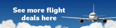 Front view of a plane flying in a deep blue sky featuring more flight deals