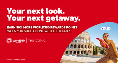 Woman with a colourful scarf sitting next to the Colosseum featuring a World360 Rewards and Iconic partnership