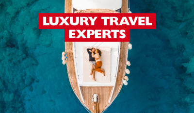 Luxury Travel Experts - couple cuddling on the bow of a luxury ship