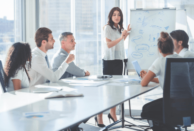 Woman giving a presentation to her team.