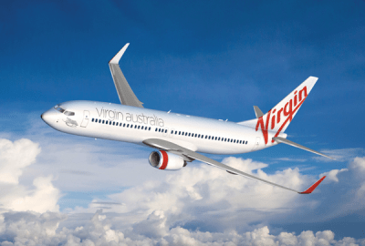 A Virgin Airlines 737-800 plane soars above the clouds