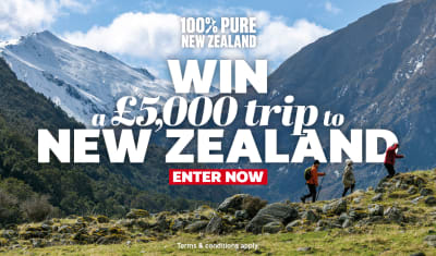 Three people hiking over rocky mountains featuring a chance to win a £5,000 trip to New Zealand