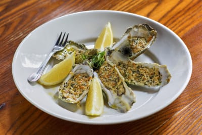 Baked oysters topped with parmesan cheese and breadcrumbs