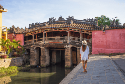 Woman walking in the old town district of Hoi An in Vietnam during a sunny day