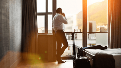 Corporate Businessman On Phone In Hotel