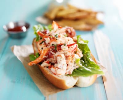 Lobster roll on colourful retro painted wooden planks