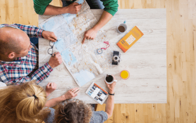 Family sitting around a table with a map planning a holiday